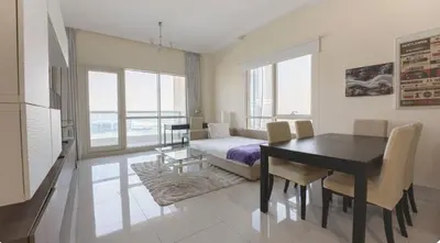a room with a dining table and a bedroom with a bed at April OFFER Huge 1BKH 4people & high floor in Dubai