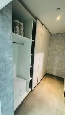 a room with a closet with white cabinets at Elegant Guesthouse in Business Bay in Dubai