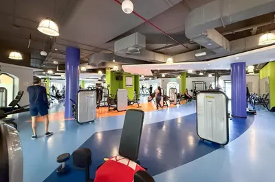 a gym with people walking and exercising in the gym at Beachside Home on JBR Walk with modern interiors in Dubai