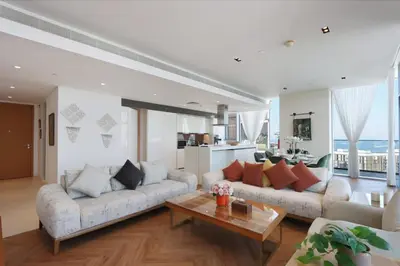 a living room with two couches and a table at Livbnb - Ain Dubai Panorama, 3BR with Maid's Room in Dubai