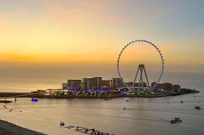 a large ferris wheel in front of a city at Livbnb - Ain Dubai Panorama, 3BR with Maid's Room in Dubai