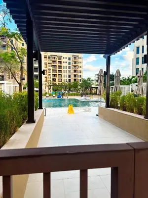a swimming pool with a yellow cone in the water at Lamtara 3 MJL in Dubai