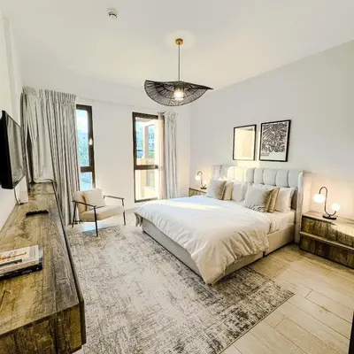 a white bedroom with a large bed and a couch at Lamtara 3 MJL in Dubai