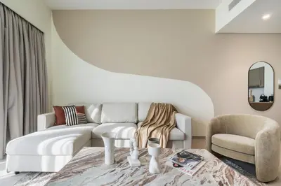 a living room with a couch and a chair at The Smart Concierge - Signature Grande in Dubai