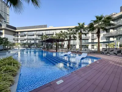 a swimming pool in the middle of a building at Stylish 1BR APT with Gym, Pool & Private Parking in Dubai