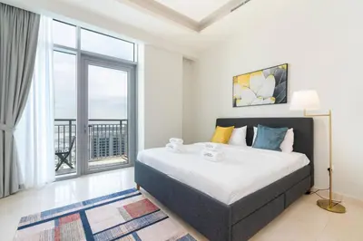 a bedroom with a large bed and a large window at Holiday Boulevard - Luxury 3BR Penthouse with Burj Khalifa and Creek Views in Dubai