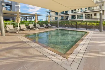 a swimming pool in the middle of a building at Waves - Stunning 1BR with Huge Terrace & Scenic Views in Dubai