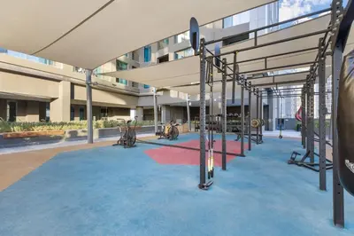 a large building with a playground in front of it at Waves - Stunning 1BR with Huge Terrace & Scenic Views in Dubai