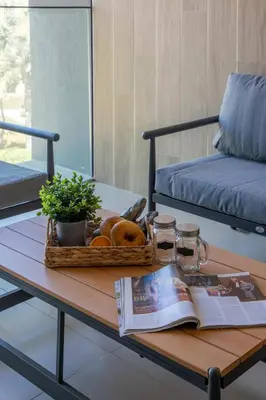 a coffee table with a book and a basket of donuts at Frank Porter - Club Villas in Dubai