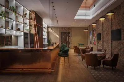 a restaurant with a bar with chairs and tables at Sky-High 2BR - Infinity Pool & Burj Khalifa Views in Dubai