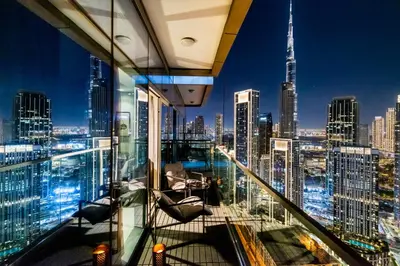 a room with a view of a city skyline at Sky-High 2BR - Infinity Pool & Burj Khalifa Views in Dubai