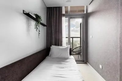 a bed in a room with a window at Sky-High 2BR - Infinity Pool & Burj Khalifa Views in Dubai