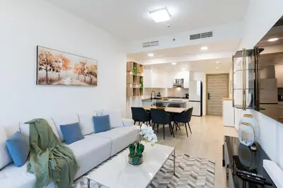 a living room with a white couch and a table at Spacious l Opened View l Fits 4 in Dubai