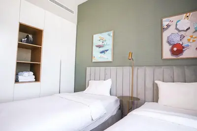 two beds sitting next to each other in a room at Sea View l Port De LaMer l Next to Beach l Perfect for 4 in Dubai