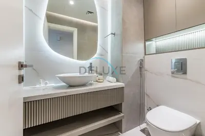 a bathroom with a sink and a toilet and a mirror at Serene 2BR with Iconic Palm Jumeirah Views, Dubai Marina by Deluxe Holiday Homes in Dubai