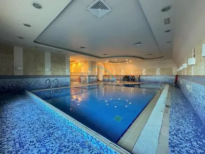 a large swimming pool in a hotel room at Serene 2BR with Iconic Palm Jumeirah Views, Dubai Marina by Deluxe Holiday Homes in Dubai