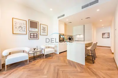 a living room with white chairs and a counter at Serene 2BR with Iconic Palm Jumeirah Views, Dubai Marina by Deluxe Holiday Homes in Dubai