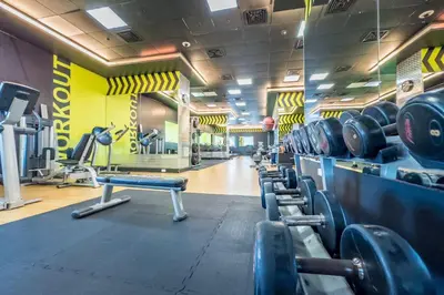 a gym with a row of dumbbells on a wall at Remodeled 1BR with Sky-High Picturesque Marina Views, Elite Residence, Dubai Marina by Deluxe Holiday Homes in Dubai