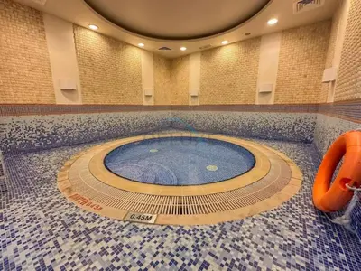 a swimming pool in a large room with a tile floor at Remodeled 1BR with Sky-High Picturesque Marina Views, Elite Residence, Dubai Marina by Deluxe Holiday Homes in Dubai