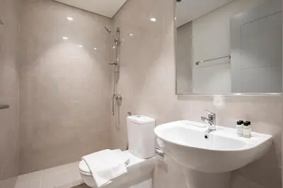 a bathroom with a toilet and a sink and a shower at FIRST CLASS 3BR Burj Khalifa & Fountain view in Dubai