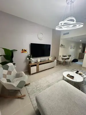 a living room with a couch and a tv at Deluxe 1BHK Apt in JVC, Self check in ! in Dubai
