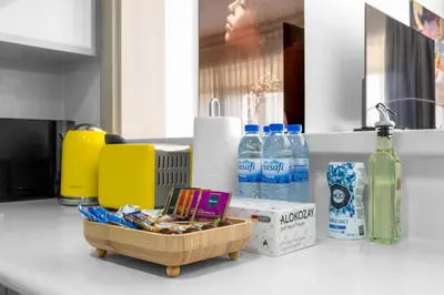 a kitchen counter with a basket of food and bottles of water at Spacious 2BR with Pool & Private Beach Access in Dubai
