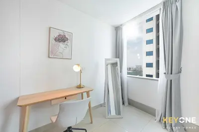 a desk and a chair in a room with a window at Fascinating Ocean Views in a One Bedroom in Dubai