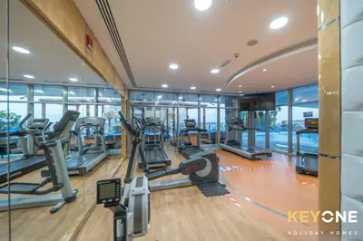 a gym with treadmills and elliptical machines at Fascinating Ocean Views in a One Bedroom in Dubai