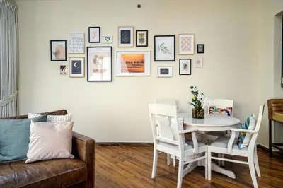a living room with a white table and chairs at Marina Majesty- Homely & Cozy 2BR, CanalView, Central Location in Dubai