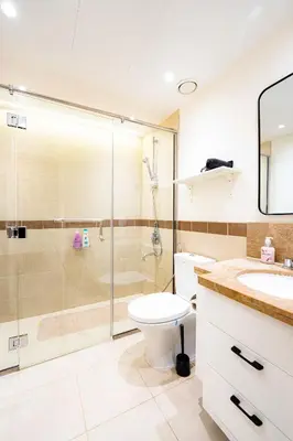 a bathroom with a shower and a toilet and a sink at Modern Studio I Boulevard View I Downtown Dubai in Dubai