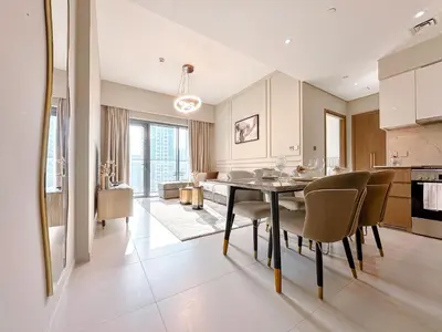 a kitchen and dining room with a table and chairs at Amazing 1 Bedroom in Burj Royale Downtown in Dubai