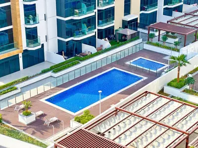 an overhead view of a swimming pool in a building at Cozy Studio in Azizi Riviera with Balcony in Meydan City in Dubai