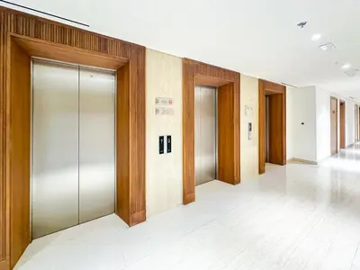 a row of elevator doors in a building at Cozy Studio in Azizi Riviera with Balcony in Meydan City in Dubai