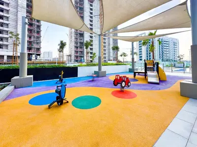 a playground with two play equipment in a building at Cozy Studio in Azizi Riviera with Balcony in Meydan City in Dubai