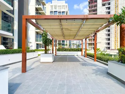 awning over a courtyard in a building at Cozy Studio in Azizi Riviera with Balcony in Meydan City in Dubai