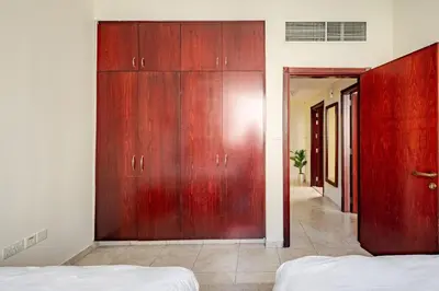 a room with a large wooden closet in a bedroom at Stylish Marina View Apartment With Private Marina Walk Access in Dubai