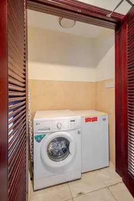 a white washer and dryer in a room at Stylish Marina View Apartment With Private Marina Walk Access in Dubai