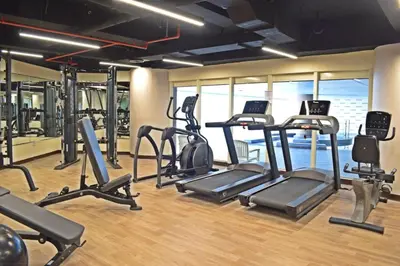 a gym with several treadmills and elliptical machines at Stylish Marina View Apartment With Private Marina Walk Access in Dubai