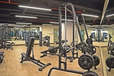 a gym with several treadmills and weights at Stylish Marina View Apartment With Private Marina Walk Access in Dubai