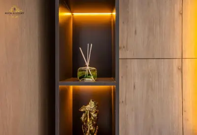 a room with a wall with two shelves with a candle at Modern Studio at The Crescent Tower B, IMPZ - In the heart of Dubai in Dubai