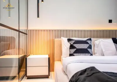 a bedroom with two beds and a glass wall at Modern Studio at The Crescent Tower B, IMPZ - In the heart of Dubai in Dubai