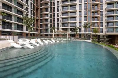 a swimming pool with lounge chairs in a building at Luxe 1BR in Citywalk with Pool Balcony & More in Dubai