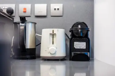 a kitchen counter with a coffee maker and a blender at Luxe 1BR in Citywalk with Pool Balcony & More in Dubai
