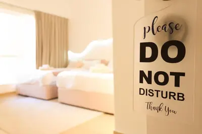 a sign that says do not disturb in a bedroom at Cozy Dubai Eye & Sunset Views - JBR Beachfront - Gym & Pool - Free Parking in Dubai