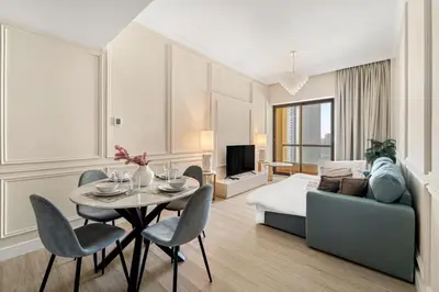 a hotel room with a bed and a table and chairs at FIRST CLASS 2BR Breathtaking Beach Views in Dubai