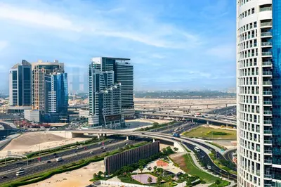 a city with tall buildings and a highway at Samaya Holiday Homes - Nobles Family Modern Suites in Dubai
