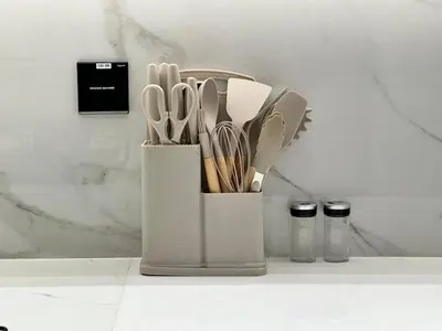 a white container filled with utensils on a counter at Bright 1br Jvc Balcony & Free Parking in Dubai