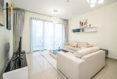 a living room with a white couch and a tv at Chic 1-Bedroom Haven in Standpoint A Tower, Downtown Dubai in Dubai