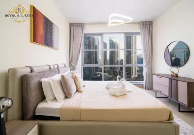 a bedroom with a bed and a large window at Chic 1-Bedroom Haven in Standpoint A Tower, Downtown Dubai in Dubai