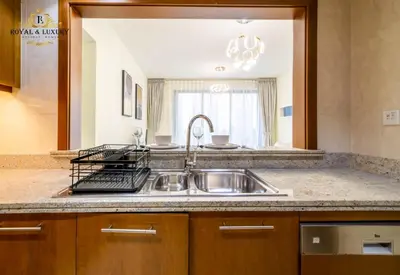 a kitchen with a stainless steel sink and a mirror at Chic 1-Bedroom Haven in Standpoint A Tower, Downtown Dubai in Dubai